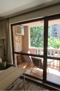a living room with a sliding glass door at Cascadas, Studio apartment with a pool view in Sunny Beach