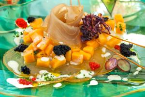 a plate of fruit and vegetables on a table at Glemerald Hostel in Pula +22 photos