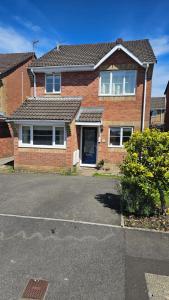 a brick house with a driveway in front of it at Olive Mae - Cosy Room with private en-suite bathroom in Blackwood