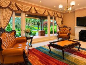 a living room with a couch and a coffee table at Oak Hill House - Chirnside Park in Wonga Park
