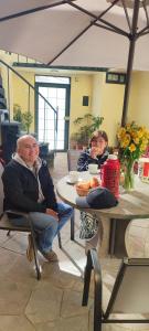 two men sitting at a table under an umbrella at Mirador wayras in Cuzco +15 photos