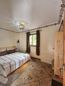 a bedroom with a large bed and a window at Azul Atlas Lodge in Imlil