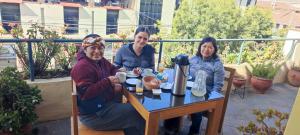 a group of three people sitting at a table at Mirador wayras in Cuzco