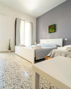 a bedroom with two beds and a window at Glemerald Hostel in Pula