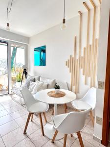 a living room with a white table and chairs at Cozy Vallevò in Rocca San Giovanni