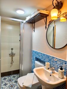 a bathroom with a shower and a sink and a mirror at Nar Adaevi in Bozcaada