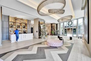 a lobby with a person walking in a store at Amazing Apartments at H Beach House in Hollywood +290 photos