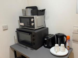 a microwave sitting on top of a black microwave oven at M18 Escape in Havering atte Bower