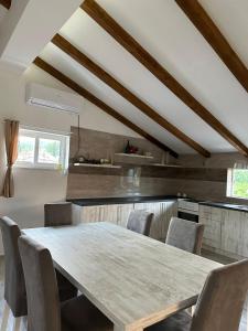 a kitchen with a wooden table and chairs at Kelesina Apartment in Ulcinj