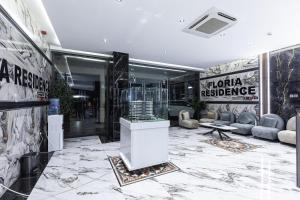 a lobby with a large marble floor and a store at FLORIA - Sky Suites in Accra +291 photos