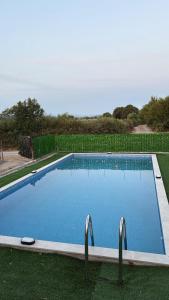 a large blue swimming pool in the grass at Kelesina Apartment in Ulcinj