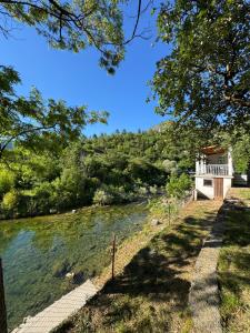 a bridge over a river with a house in the background at Vikendica Jazina in Lastva