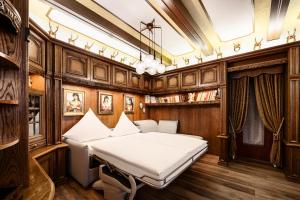 a bedroom with a bed in a room with wood paneling at Haus der Weine in Rüdesheim am Rhein