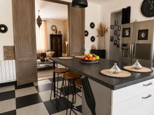 a kitchen with a island with a bowl of fruit on it at BARREAU in Libourne