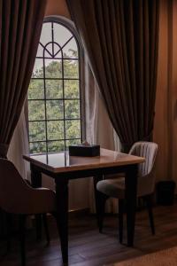 a table with a cake on it in front of a window at Pak Hospitality in Islamabad