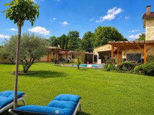 a yard with two lounge chairs and a pool at BARREAU in Libourne