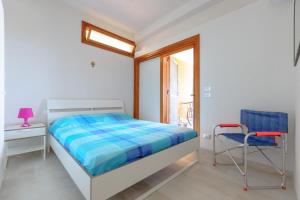 a bedroom with a bed and a desk and a chair at Piccola Baia in Scopello