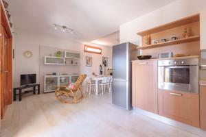a kitchen with a table and a dining room at Piccola Baia in Scopello