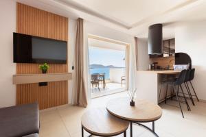 a living room with a view of the ocean at Latsis Suites in Plytra