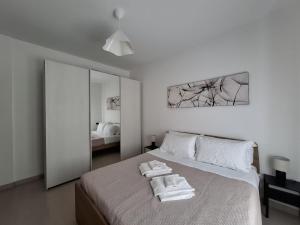 a bedroom with a bed with two towels on it at Eira Apartment Potenza in Potenza