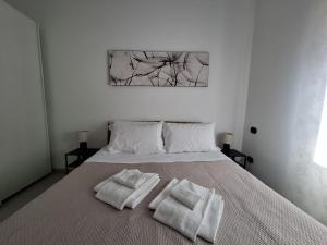 a bedroom with a bed with two towels on it at Eira Apartment Potenza in Potenza +8 photos