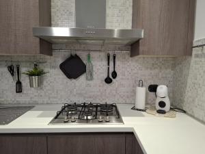 a kitchen with a stove top oven in a kitchen at Eira Apartment Potenza in Potenza