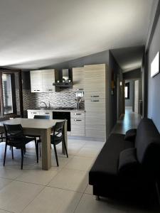 a living room with a couch and a table at L'attico di Greta,Etna house in Mascalucia