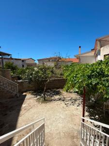 a yard with a white fence and a tree at Casa Bella Tania in Briatico