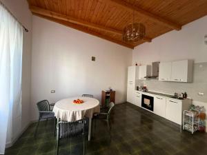 a kitchen with a table and chairs in a room at Casa Bella Tania in Briatico