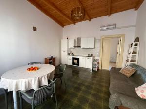 a kitchen and a living room with a table and chairs at Casa Bella Tania in Briatico +24 photos