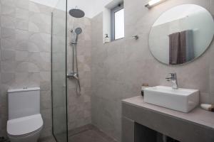 a bathroom with a toilet and a sink and a mirror at GK Home Studios part of GK FITNESS CLUB in Faliraki +55 photos