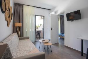 a living room with a couch and a table at GK Home Studios part of GK FITNESS CLUB in Faliraki