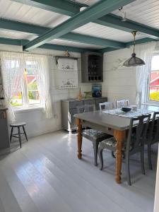 a kitchen with a table and chairs in a room at Heritage House in Lofoten with Modern Comfort & Scenic Views in Jerstad