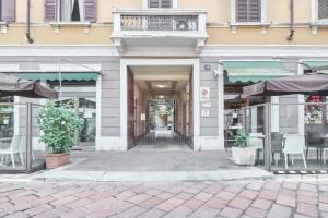 a store front with tables and chairs in a building at Emmeloft I Orange Moon - Vibrant Modern Luxury Loft Milan in Milan