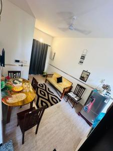 a living room with a table and a couch at Coastal villa in Tirupporūr