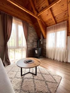 a living room with a table and a couch at Underwoods_chill in Žabljak
