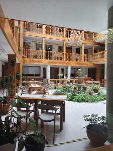 a large room with a table and chairs in a building at Hotel Aural in Cajamarca