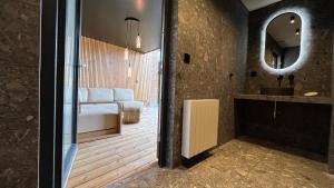 a bathroom with a bed and a sink and a mirror at Le Clos Boréal - Gîte Spa Privatif in Lens +32 photos