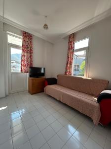 a living room with a couch and a television at Double Comfort Marmaris in Marmaris