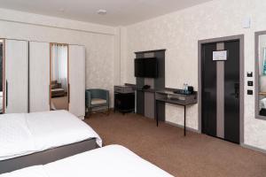 a hotel room with a bed and a desk at Gulshan Hotel in Urganch