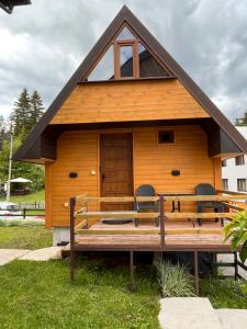 a cabin with a bench in front of it at Underwoods_chill in Žabljak