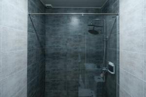 a bathroom with a shower with a glass door at Gulshan Hotel in Urganch +44 photos