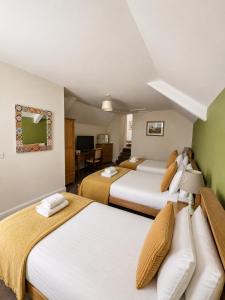 a hotel room with two beds and a living room at The Cornerhouse in Frome