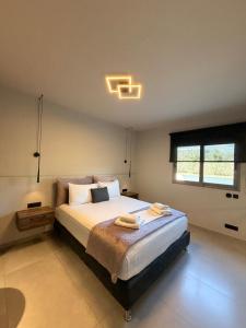 a bedroom with a bed with two towels on it at Animus Premium apt in Nafplio