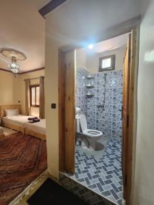 a bathroom with a shower and a toilet in a room at Azul Atlas Lodge in Imlil