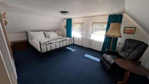 a bedroom with a bed and a chair and a window at 7Rooms in Telnice