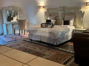 a bedroom with a large bed and a mirror at One love suites in Mokopane +42 photos