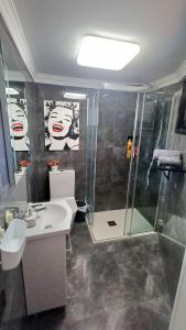a bathroom with a sink and a shower at Ocean View Studio in Playa del Ingles in San Bartolomé