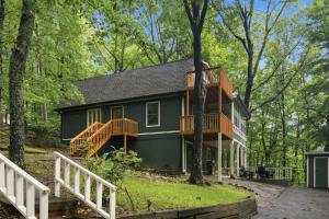 a house with a wrap around deck in the woods at Sharp Top Mountain Retreat in Jasper