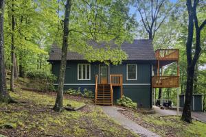 a tiny house with a deck in the woods at Sharp Top Mountain Retreat in Jasper +37 photos